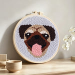 Cute pug punch needle artwork displayed on a table