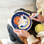 Creating handmade cute puppy on a rainbow moon punch needle artwork