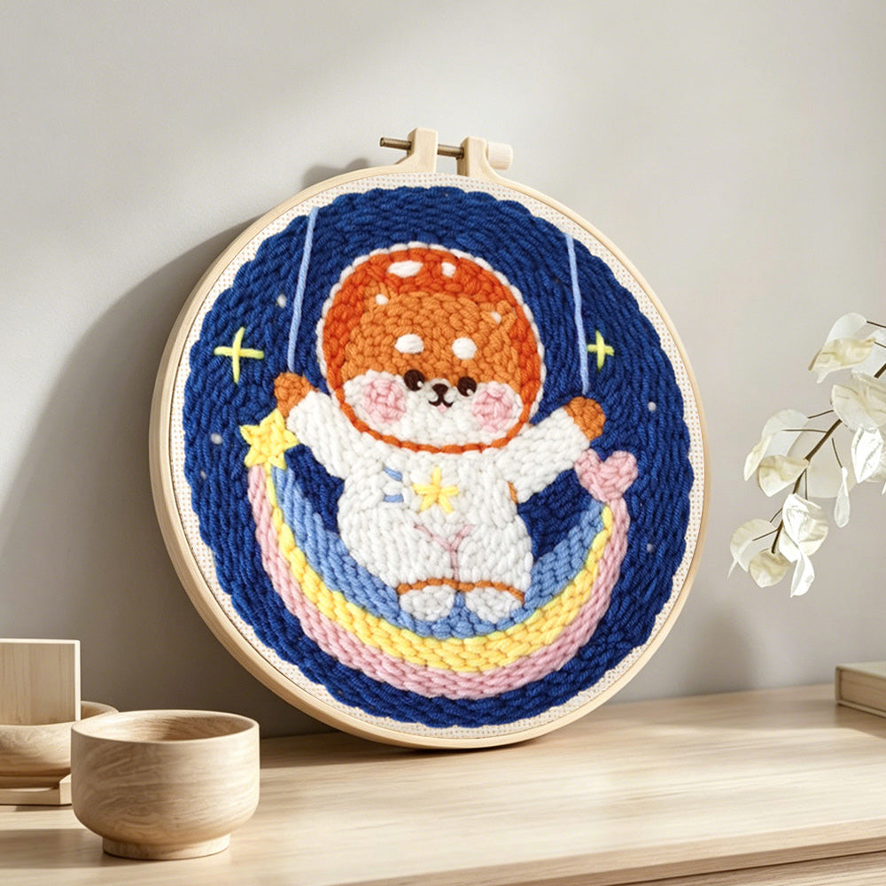 Cute puppy on a rainbow moon punch needle artwork displayed on a table
