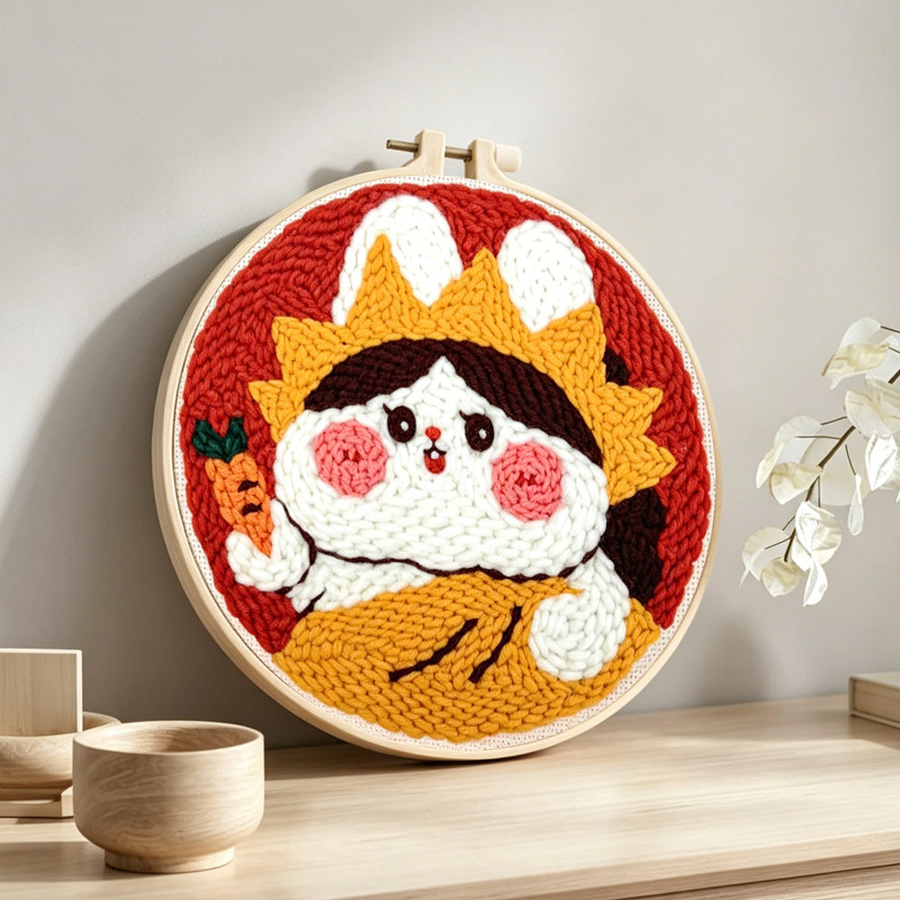 Cute rabbit with crown and carrot punch needle artwork displayed on a table