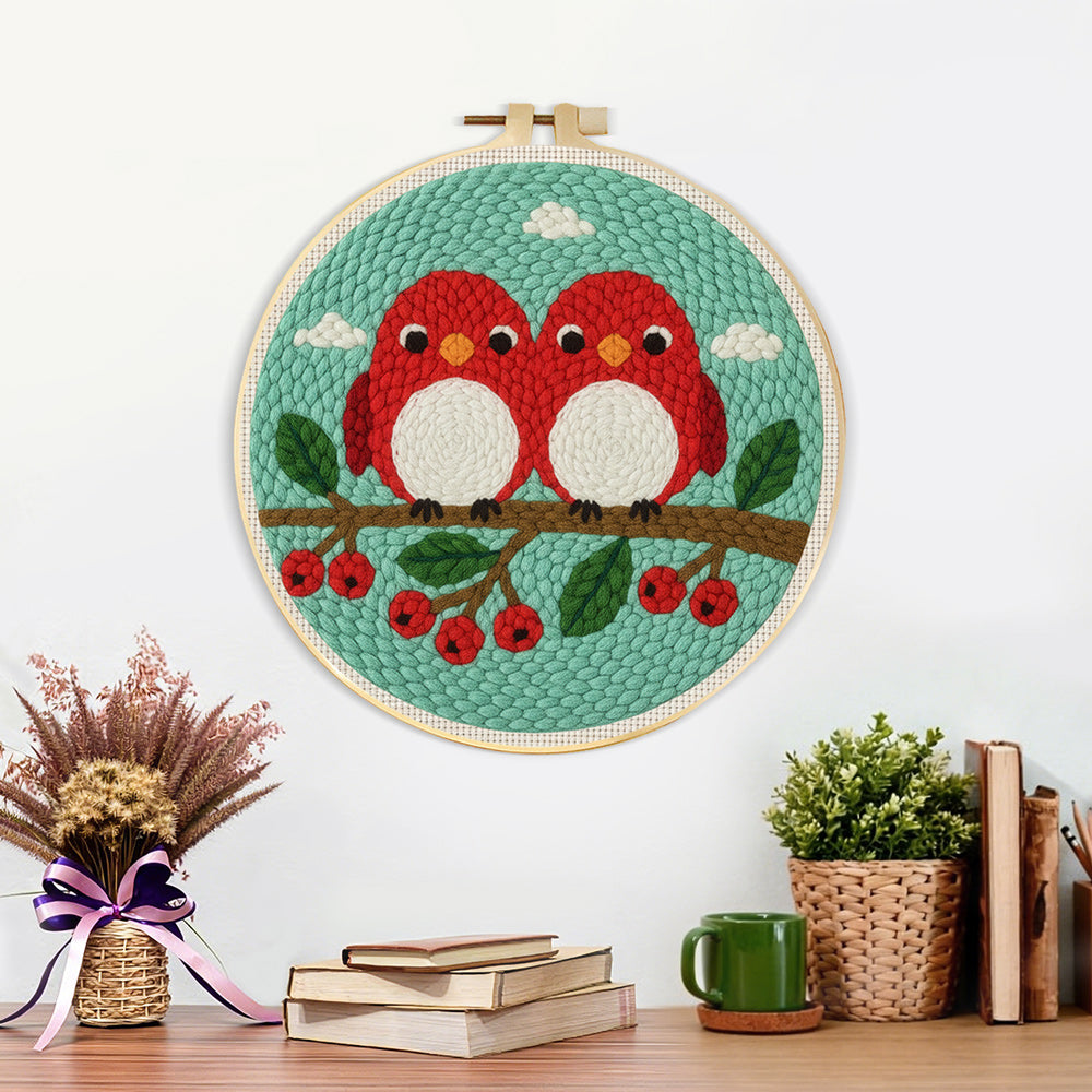 Finished cute red birds on berry branch artwork displayed on a wall
