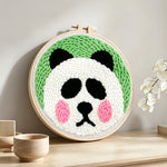 Cute round panda punch needle artwork displayed on a table