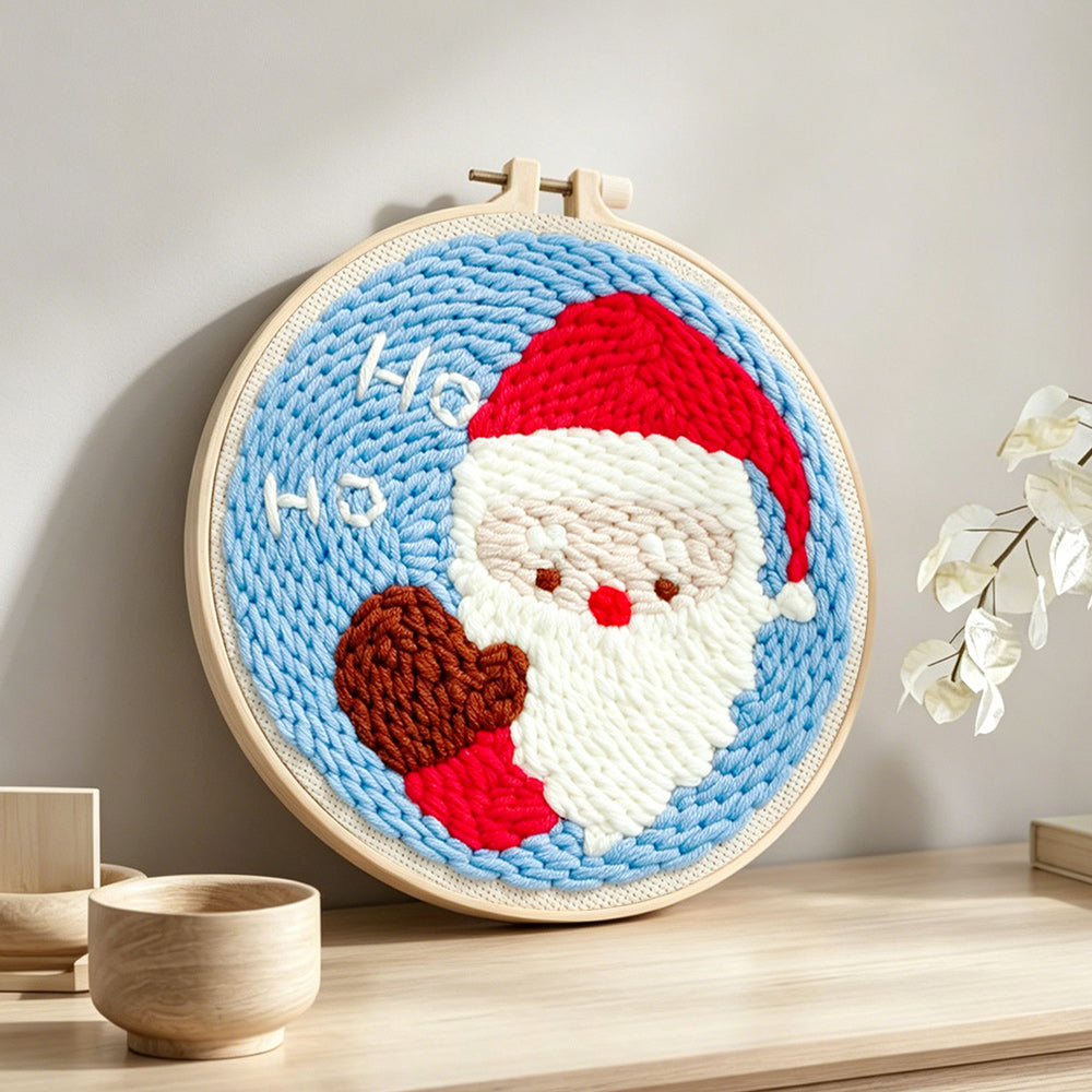 Cute santa claus “ho ho” punch needle artwork displayed on a table