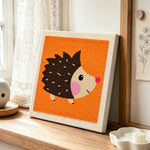 Cute side-profile hedgehog punch needle artwork displayed on a table
