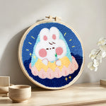Cute sleeping cloud bunny punch needle artwork displayed on a table