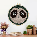 Finished cute sloth face artwork displayed on a wall