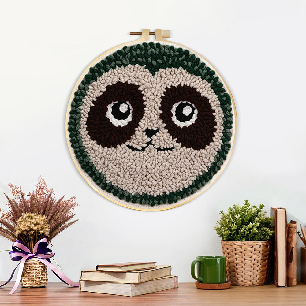 Finished cute sloth face artwork displayed on a wall