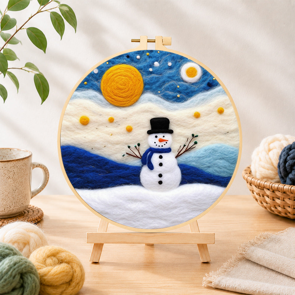 Finished cute snowman under the full moon needle felting displayed on a wooden easel