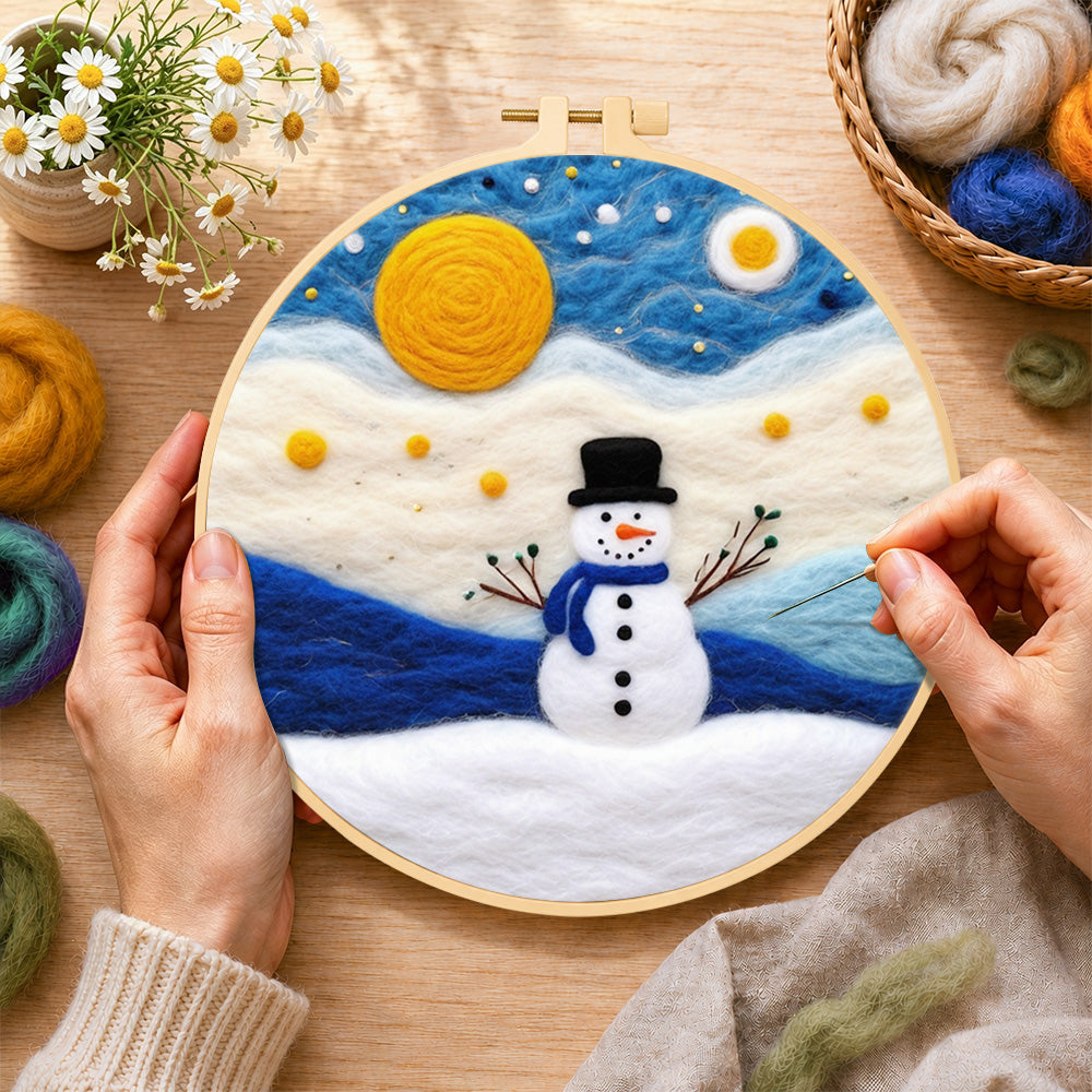 Creating the cute snowman under the full moon wool painting by hand with a felting needle
