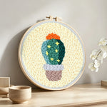 Cute starry cactus punch needle artwork displayed on a table