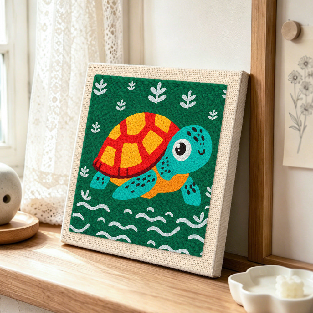 Cute swimming sea turtle punch needle artwork displayed on a table