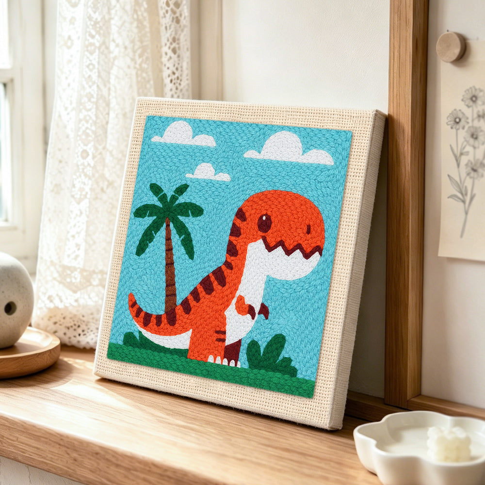 Cute t-rex with palm tree punch needle artwork displayed on a table