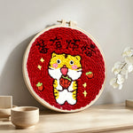 Cute tiger with "no worries" text punch needle artwork displayed on a table