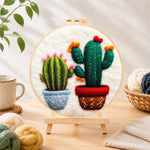 Finished cute twin potted cacti needle felting displayed on a wooden easel