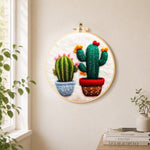 Cute twin potted cacti needle felt wall art displayed in a bright home interior