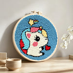Cute unicorn with hearts punch needle artwork displayed on a table