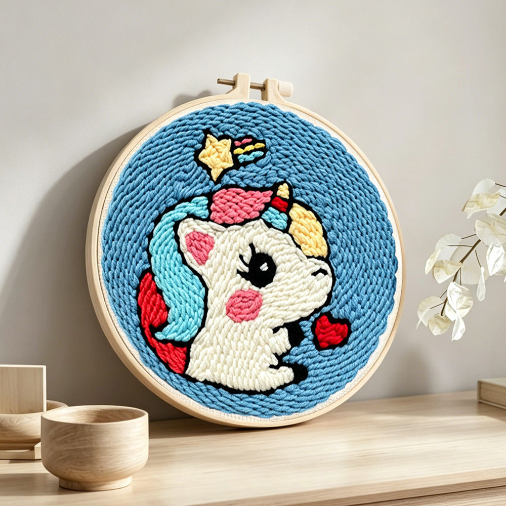 Cute unicorn with hearts punch needle artwork displayed on a table
