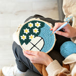 Creating handmade cute window view with white flowers punch needle artwork