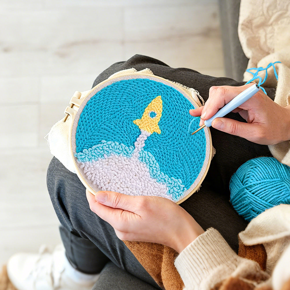 Creating handmade cute yellow rocket launch punch needle artwork