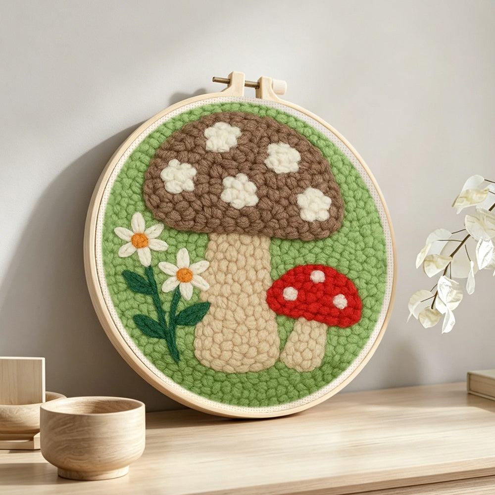 Daisies and mushrooms punch needle artwork displayed on a table
