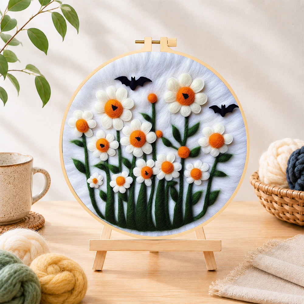 Finished daisies with bats on white needle felting displayed on a wooden easel