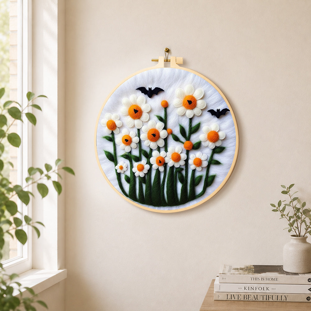 Daisies with bats on white needle felt wall art displayed in a bright home interior