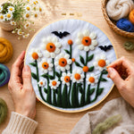 Creating the daisies with bats on white wool painting by hand with a felting needle