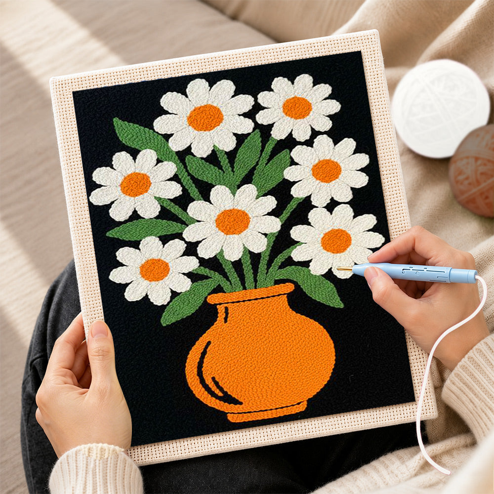 Creating handmade daisy flowers in orange vase punch needle artwork