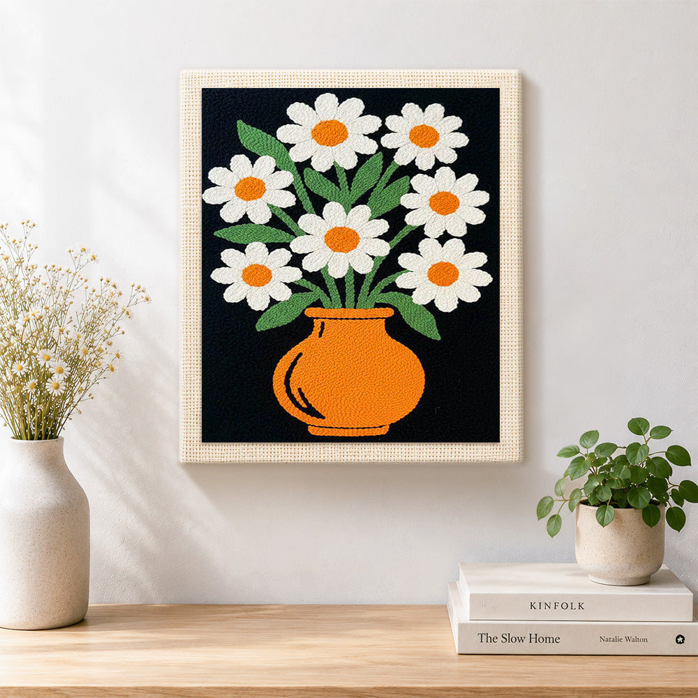 Finished daisy flowers in orange vase artwork displayed on a wall