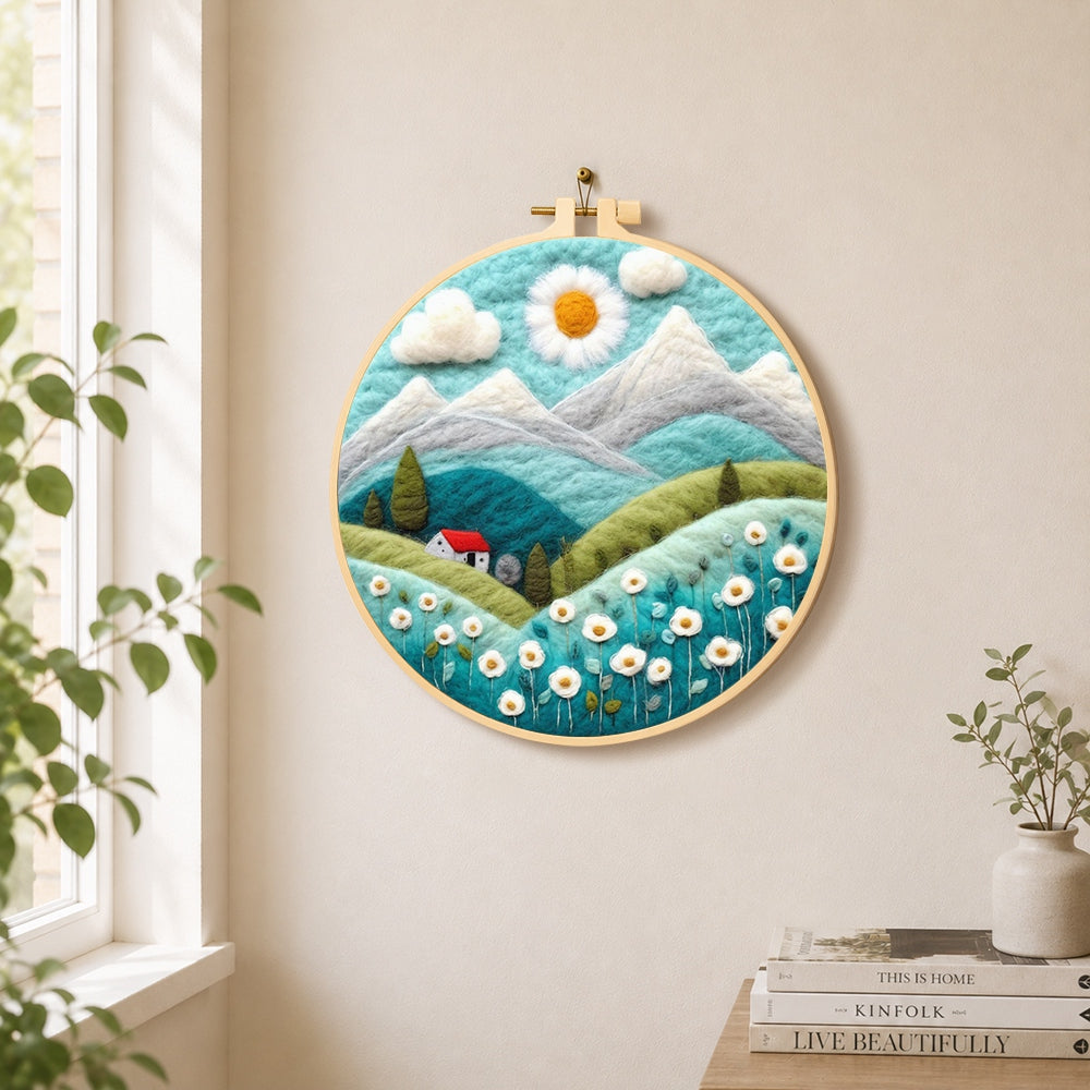 Daisy sun and red cottage in the alps needle felt wall art displayed in a bright home interior