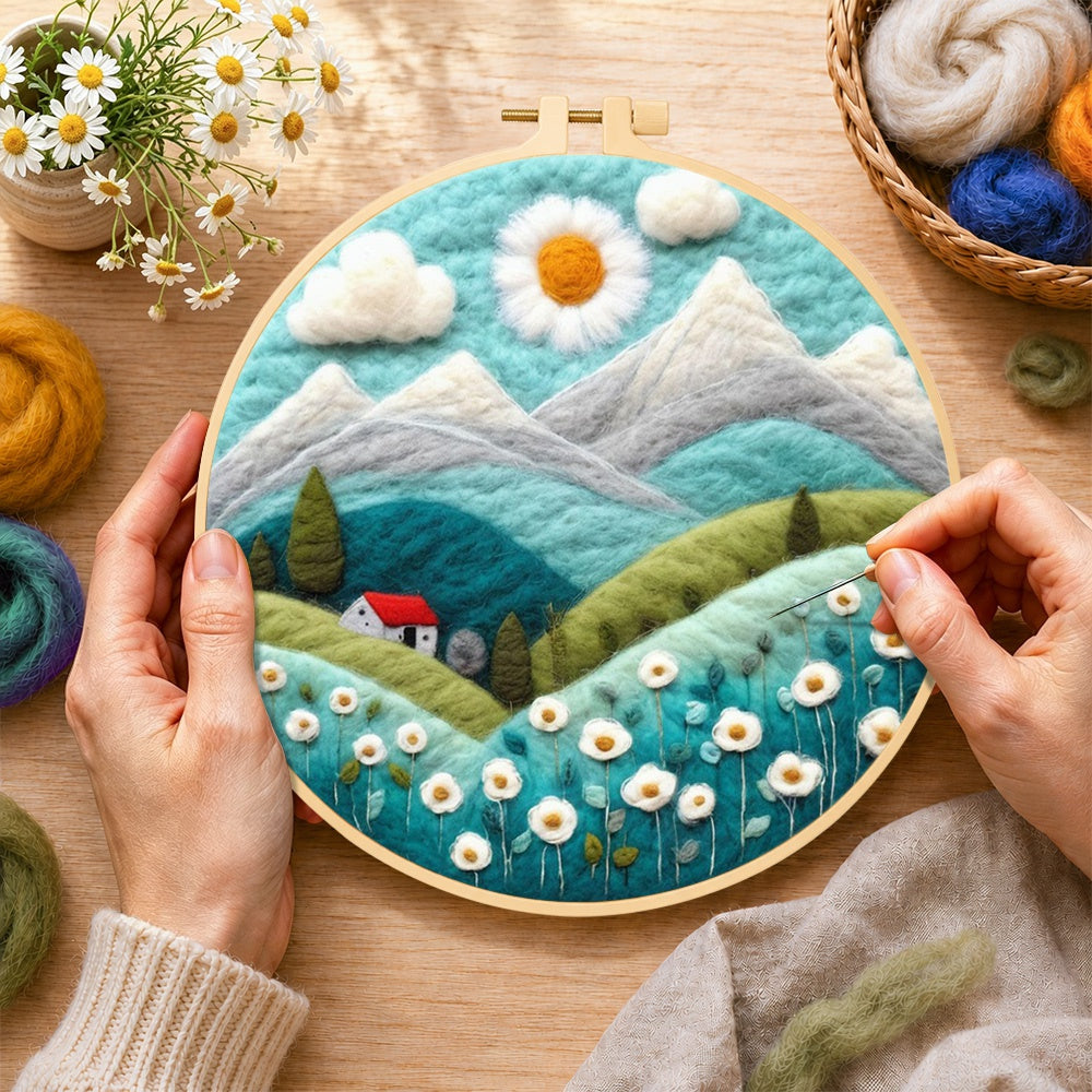 Creating the daisy sun and red cottage in the alps wool painting by hand with a felting needle