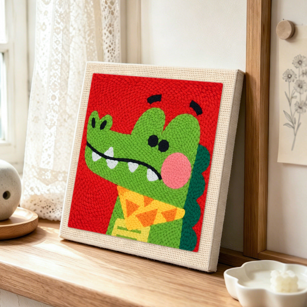 Dapper crocodile with bow tie punch needle artwork displayed on a table