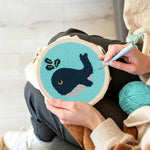 Creating handmade dark blue whale punch needle artwork
