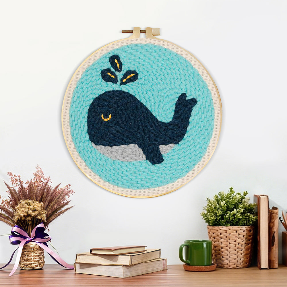 Finished dark blue whale artwork displayed on a wall