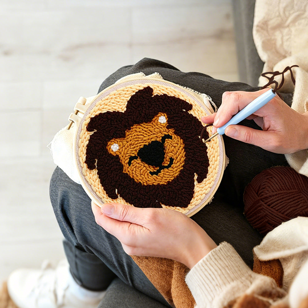 Creating handmade dark brown lion face punch needle artwork
