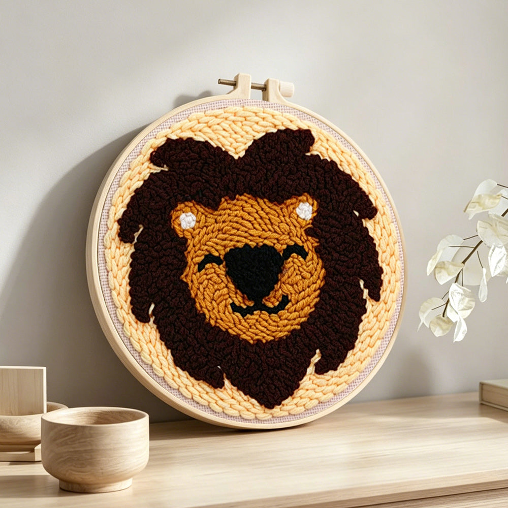 Dark brown lion face punch needle artwork displayed on a table