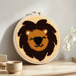 Dark brown lion face punch needle artwork displayed on a table