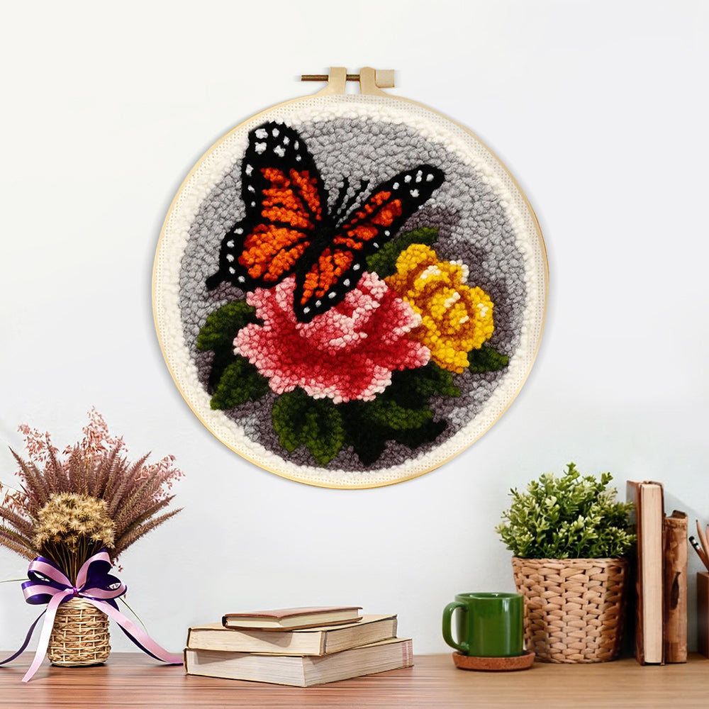 Finished dark-coloured butterfly and flowers artwork displayed on a wall