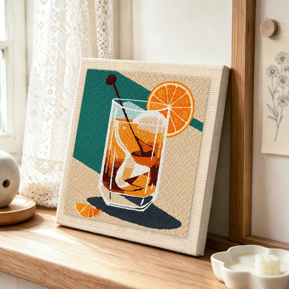Dark spirit cocktail punch needle artwork displayed on a table