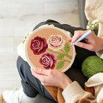 Creating handmade deep pink and cream roses punch needle artwork