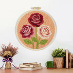 Finished deep pink and cream roses artwork displayed on a wall