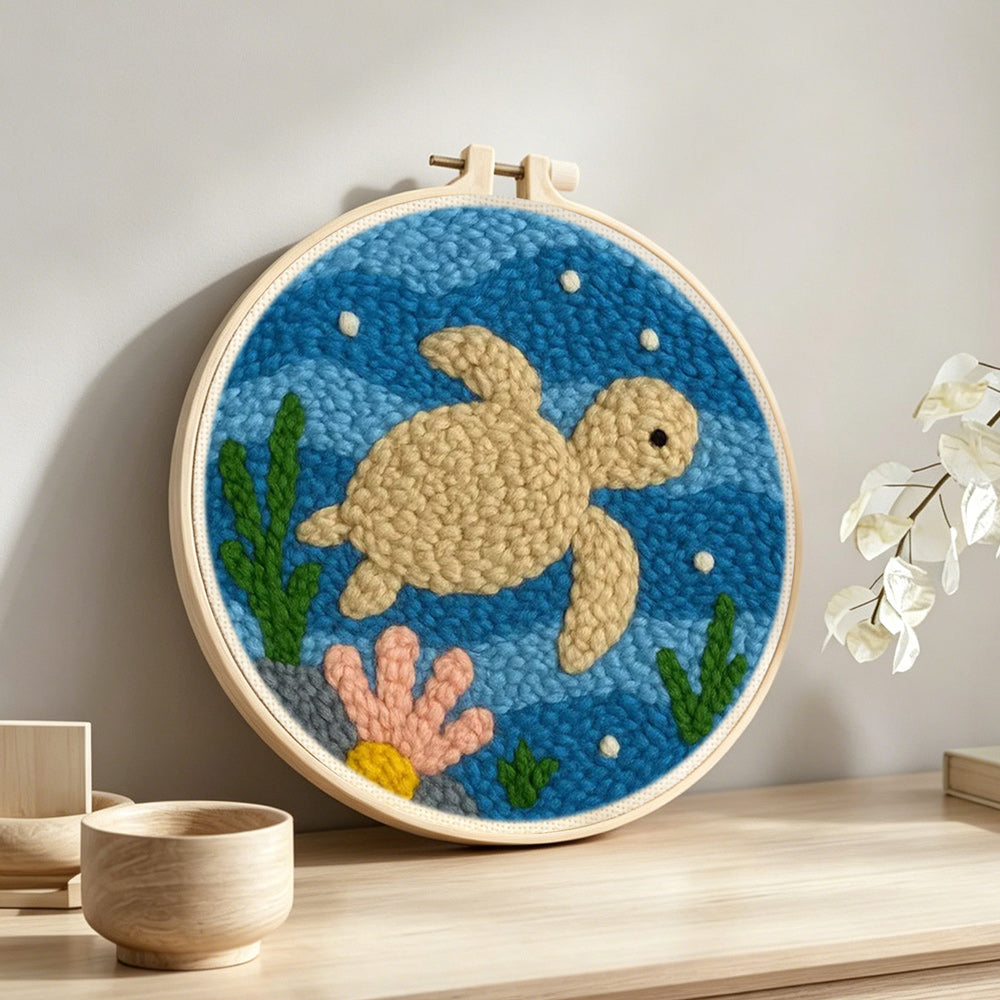 Deep-sea turtle punch needle artwork displayed on a table