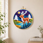 Deer with white antlers in purple night needle felt wall art displayed in a bright home interior