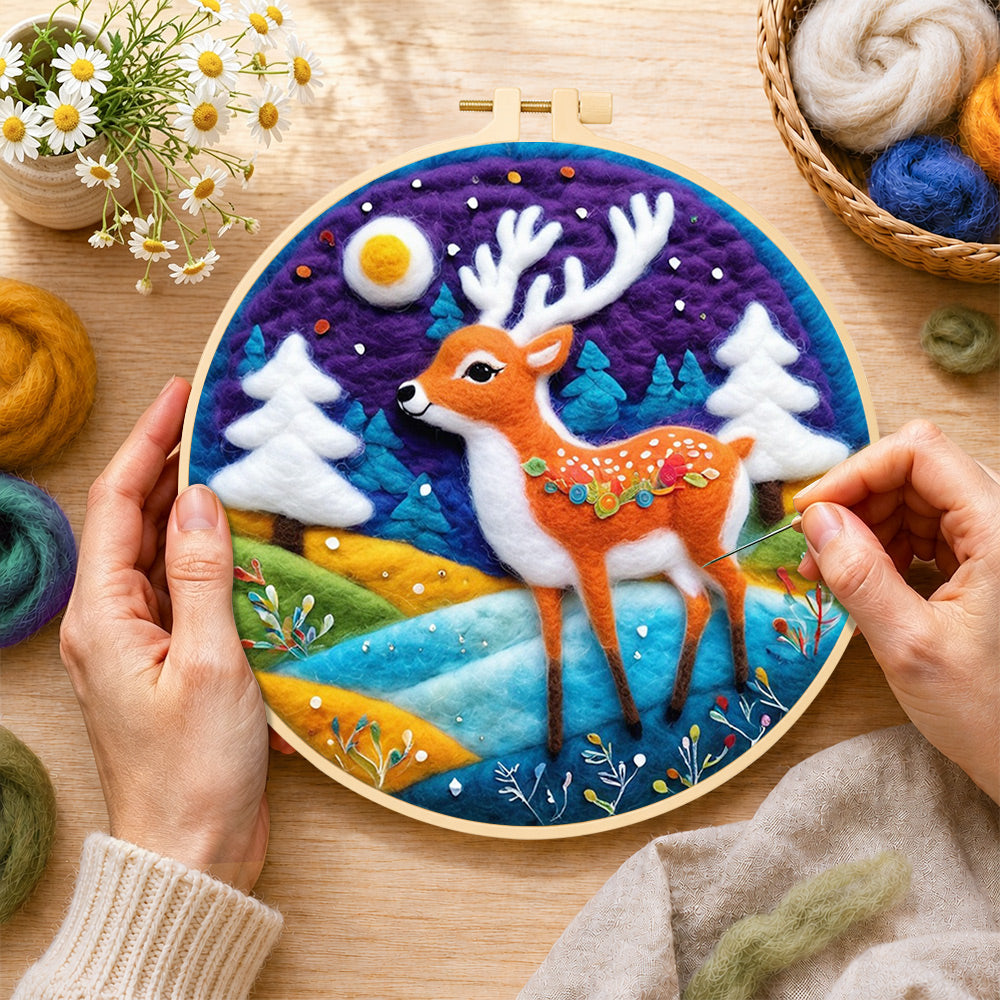 Creating the deer with white antlers in purple night wool painting by hand with a felting needle