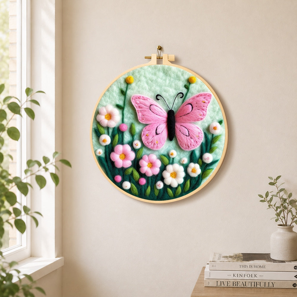 Delicate pink butterfly and flowers needle felt wall art displayed in a bright home interior