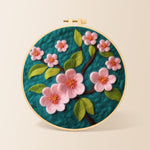 Delicate pink flowers on dark green needle felting kit for beginners with a round wooden frame