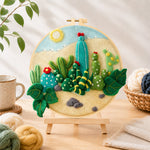 Finished desert cacti under the sun needle felting displayed on a wooden easel