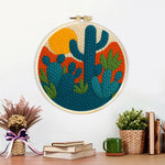 Finished desert cactus artwork displayed on a wall
