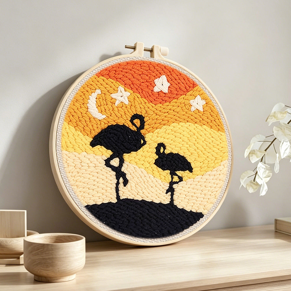 Desert flamingos at night punch needle artwork displayed on a table