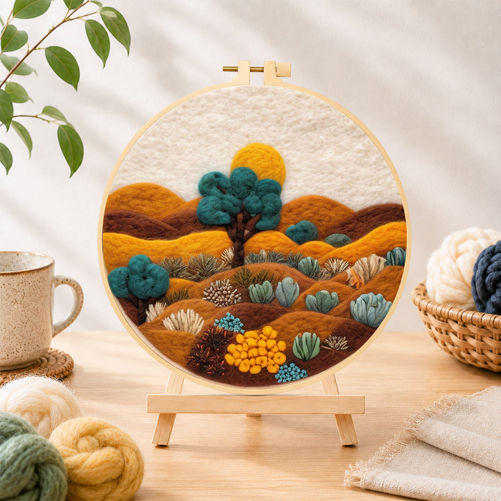 Finished desert landscape with succulents needle felting displayed on a wooden easel